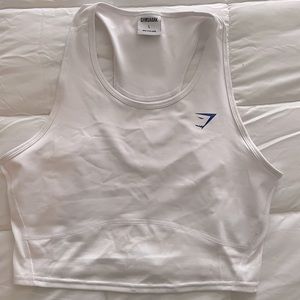 White Gymshark tank with the classic navy blue logo. Worn once due to size.